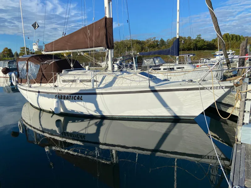 Slide: The Image of 1981 CS 33 sailboat docked in a marina. - 10