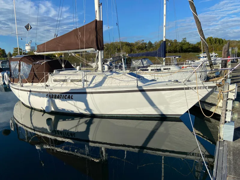 Slide: The Image of 1981 CS 33 sailboat docked in a marina. - 11
