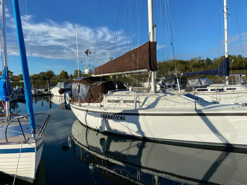 Slide: The Image of 1981 CS 33 sailboat docked in harbor, calm waters. - 12