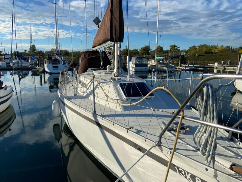 Slide: The Image of 1981 CS 33 sailboat docked in a marina. - 16