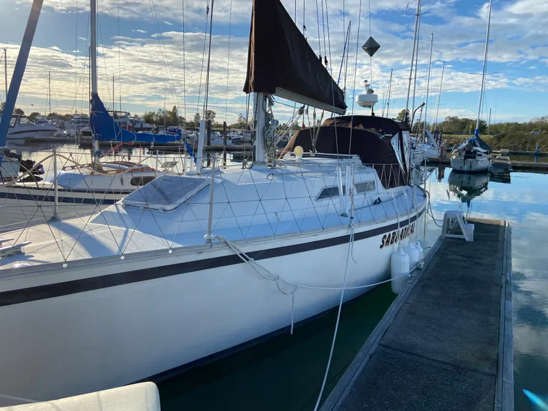 Slide: The Image of 1981 CS 33 sailboat docked in a marina. - 9