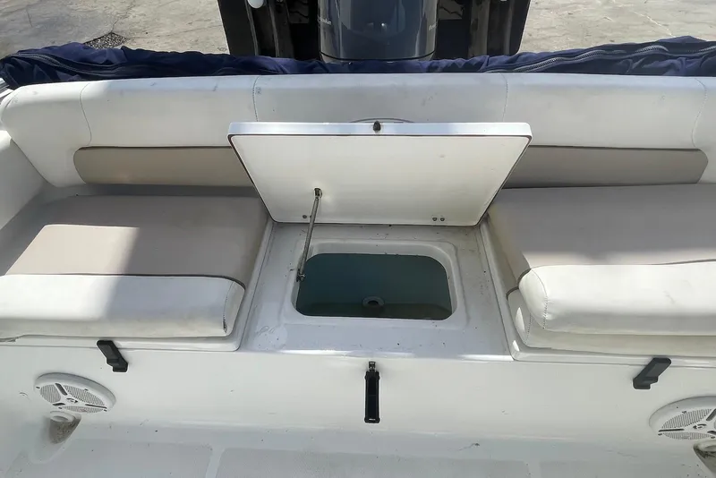 Slide: The Image of 2013 Sea Hunt Escape 211 LE boat interior with open storage compartment. - 10