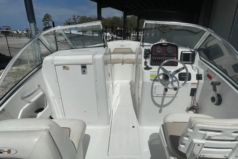 Slide: The Image of 2013 Sea Hunt Escape 211 LE boat interior with steering console and seating. - 2