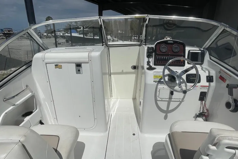 Slide: The Image of 2013 Sea Hunt Escape 211 LE boat interior with steering wheel and dashboard controls. - 3