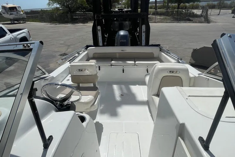 Slide: The Image of 2013 Sea Hunt Escape 211 LE boat interior with seating and steering wheel. - 6