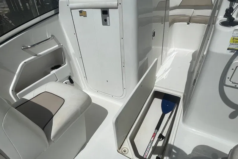 Slide: The Image of 2013 Sea Hunt Escape 211 LE boat interior with storage compartment and seating. - 7