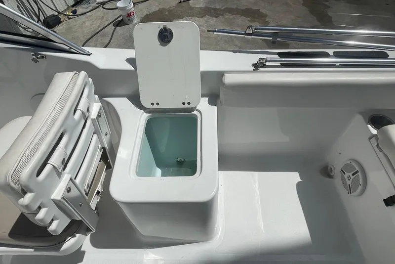 Slide: The Image of 2013 Sea Hunt Escape 211 LE boat interior with open storage compartment and seating. - 8