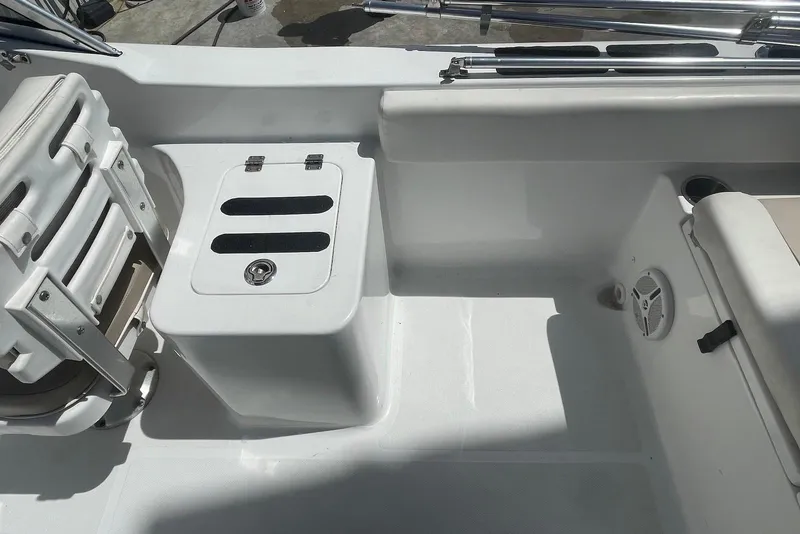 Slide: The Image of Interior view of a 2013 Sea Hunt Escape 211 LE boat, featuring seating and storage. - 9