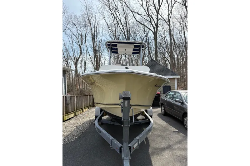 Slide: The Image of 2014 Sea Hunt Triton 202 boat on trailer, parked in driveway near trees. - 8