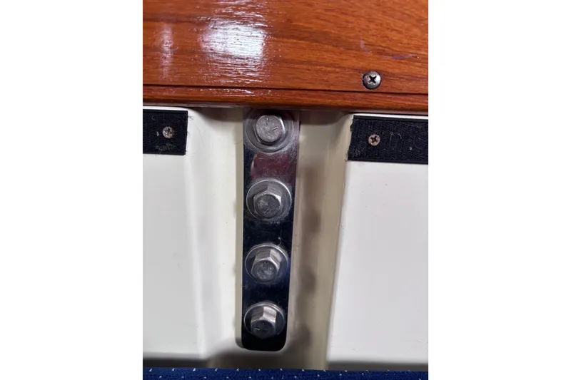 Slide: The Image of Close-up of bolts on a 1986 Pearson 28 sailboat, featuring wood and metal details. - 16