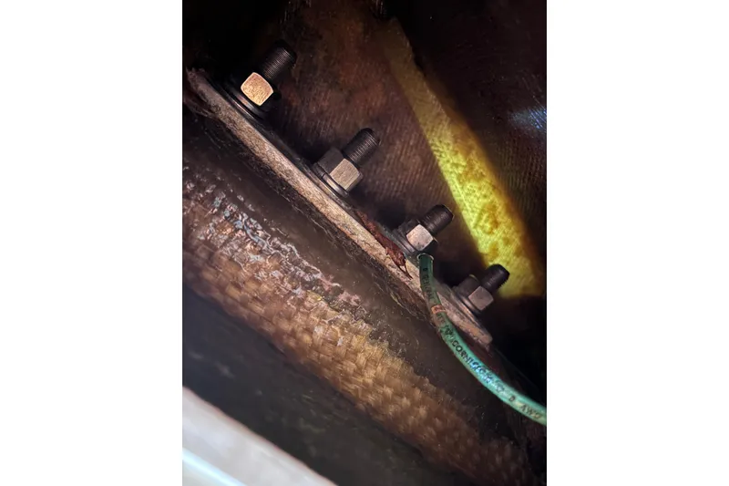 Slide: The Image of Close-up of bolts and wiring inside a 1986 Pearson 28 sailboat. - 17