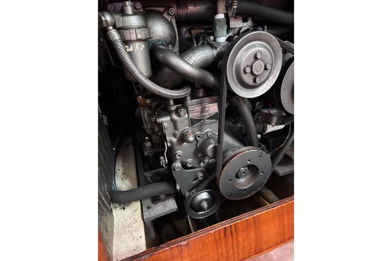 Slide: The Image of Engine of a 1986 Pearson 28 sailboat, showcasing belts and pulleys. - 18