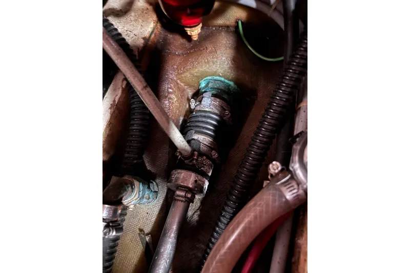 Slide: The Image of Close-up of mechanical components in a 1986 Pearson 28 boat engine compartment. - 19