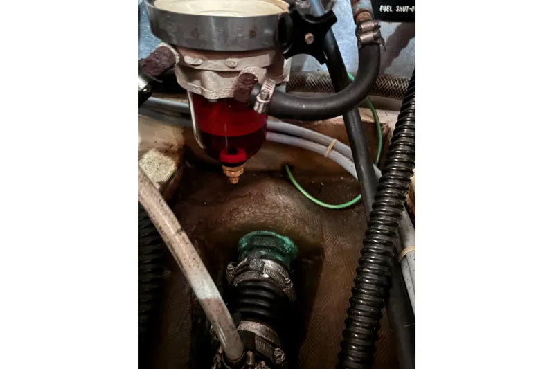 Slide: The Image of Engine compartment of a 1986 Pearson 28 sailboat showing fuel system components. - 20