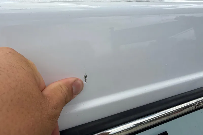 Slide: The Image of Close-up of a small crack on a 2022 Century 2600 Center Console boat hull. - 10