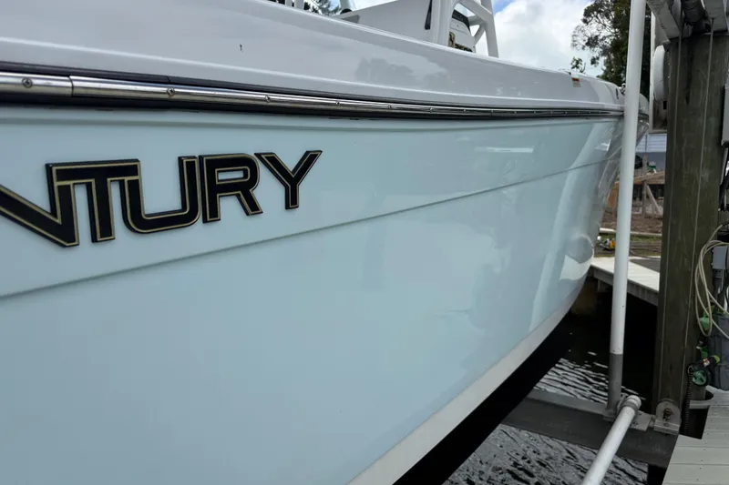 Slide: The Image of 2022 Century 2600 Center Console boat docked, showcasing sleek design and branding. - 11