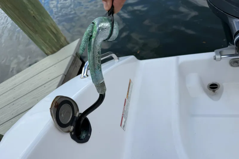 Slide: The Image of Boat fuel filler cap on a 2022 Century 2600 Center Console near dock. - 14