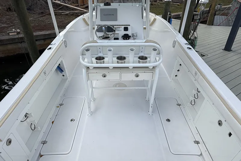 Slide: The Image of 2022 Century 2600 Center Console boat interior with Garmin navigation system and rod holders. - 17