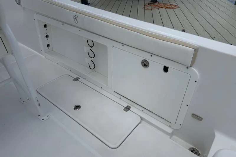 Slide: The Image of 2022 Century 2600 Center Console boat interior with storage compartments and seating. - 23