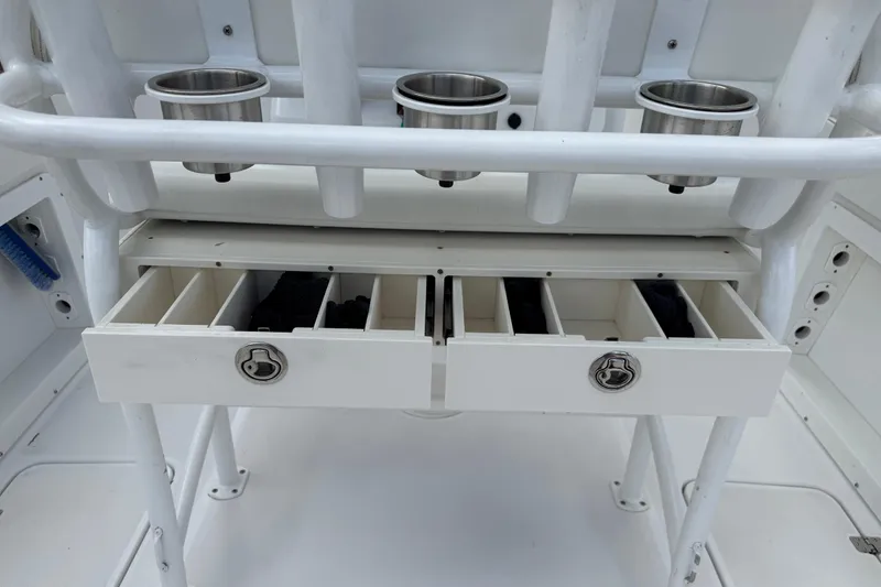 Slide: The Image of 2022 Century 2600 Center Console boat storage drawers and cup holders. - 26
