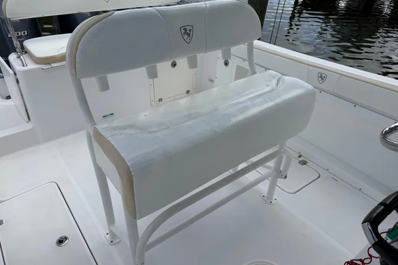 Slide: The Image of 2022 Century 2600 Center Console boat seating area with white cushioned bench. - 27