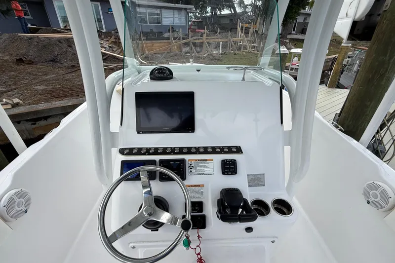 Slide: The Image of 2022 Century 2600 Center Console boat dashboard with steering wheel and navigation display. - 33