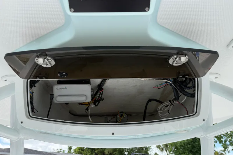 Slide: The Image of Open electronics compartment on 2022 Century 2600 Center Console boat, featuring Garmin equipment. - 41