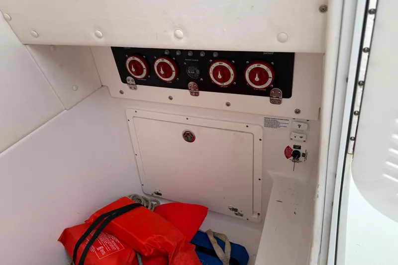 Slide: The Image of Electrical panel and life jackets in a 2022 Century 2600 Center Console boat. - 46