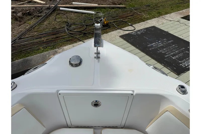 Slide: The Image of Bow view of 2022 Century 2600 Center Console boat, docked with visible deck details. - 55