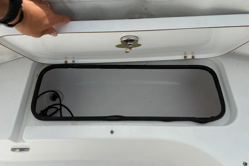 Slide: The Image of Open storage compartment on a 2022 Century 2600 Center Console boat. - 56