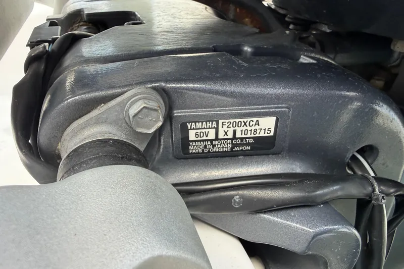 Slide: The Image of Close-up of a Yamaha F200XCA engine on a 2022 Century 2600 Center Console boat. - 59