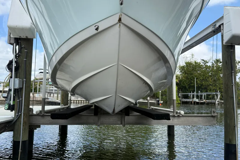 Slide: The Image of 2022 Century 2600 Center Console boat on lift, dockside view. - 9