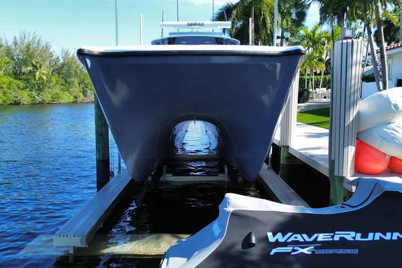 Slide: The Image of 2019 Freeman 42LR boat docked near water, with WaveRunner FX Series nearby. - 13