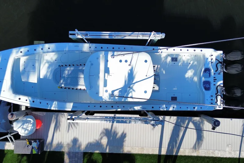 Slide: The Image of Overhead view of a 2019 Freeman 42LR boat docked by a wooden pier. - 18