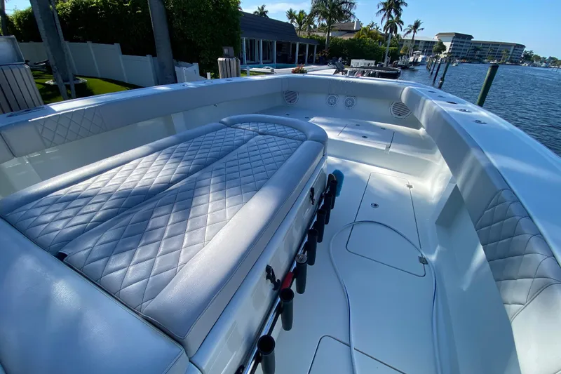 Slide: The Image of Luxurious 2019 Freeman 42LR boat interior with quilted seating, docked by waterfront homes. - 25