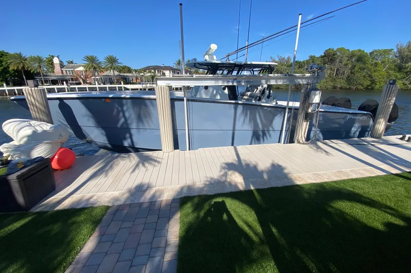 Slide: The Image of 2019 Freeman 42LR boat docked by a scenic waterfront with palm trees. - 30