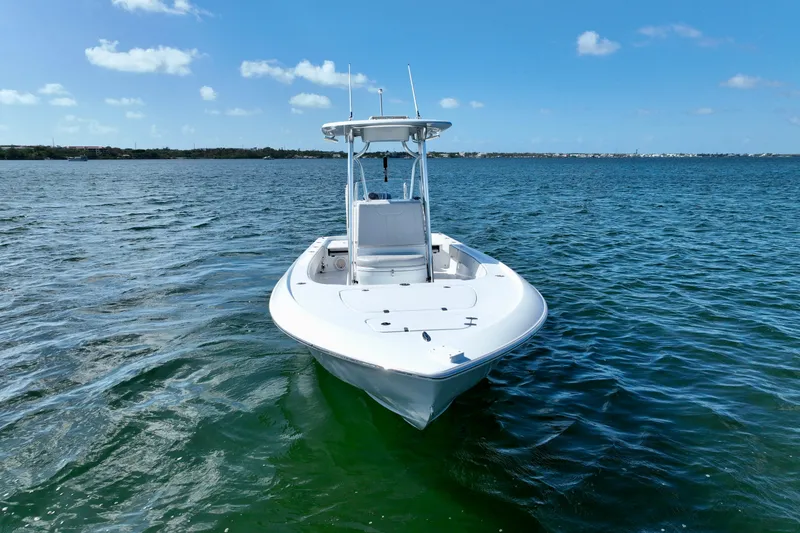 Slide: The Image of 2025 Contender 26 Bay boat on calm blue water under clear sky. - 11