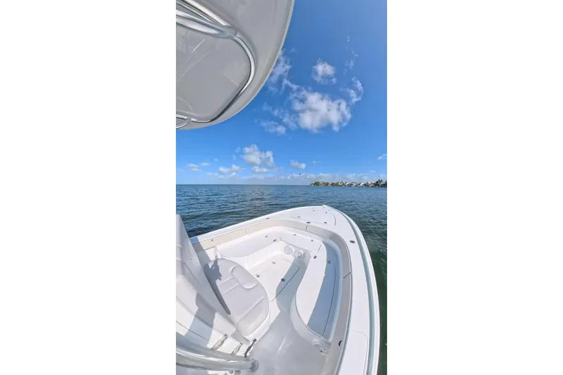 Slide: The Image of 2025 Contender 26 Bay boat on calm waters under a clear blue sky. - 15