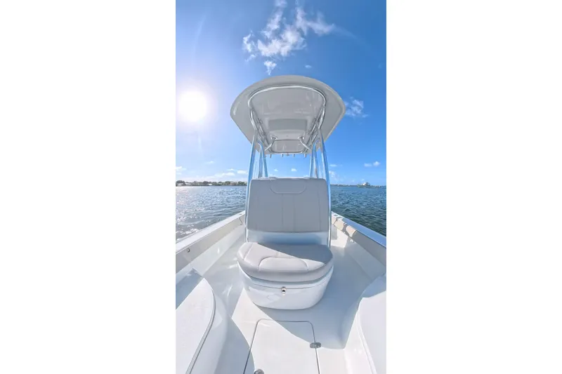 Slide: The Image of 2025 Contender 26 Bay boat on water under clear blue sky. - 16
