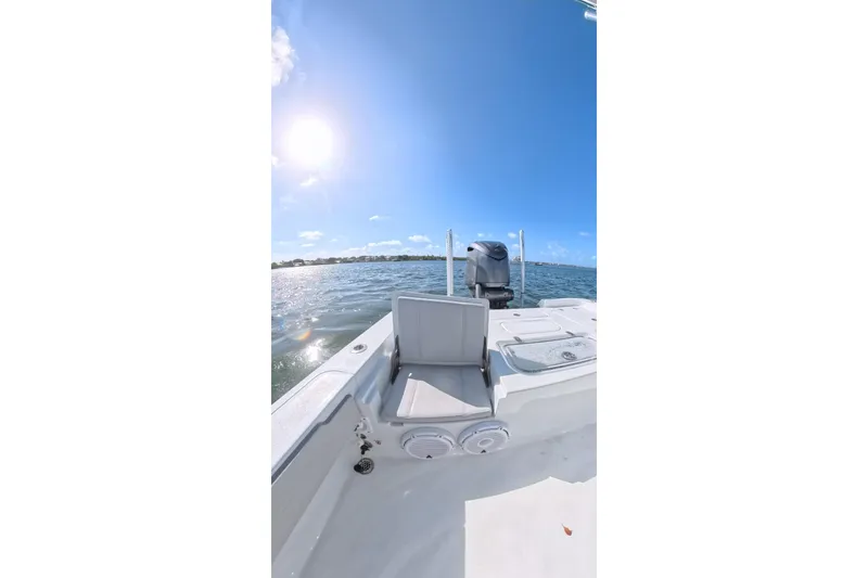 Slide: The Image of 2025 Contender 26 Bay boat on water under clear blue sky. - 22