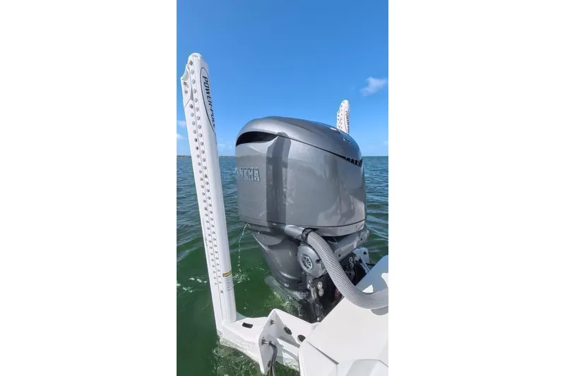 Slide: The Image of 2025 Contender 26 Bay boat with Yamaha outboard motor on open water. - 26