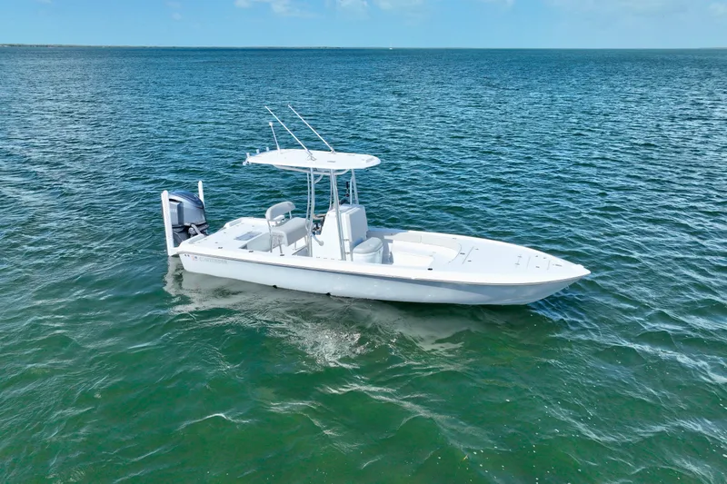 Slide: The Image of 2025 Contender 26 Bay boat on calm blue water, showcasing sleek design and modern features. - 3