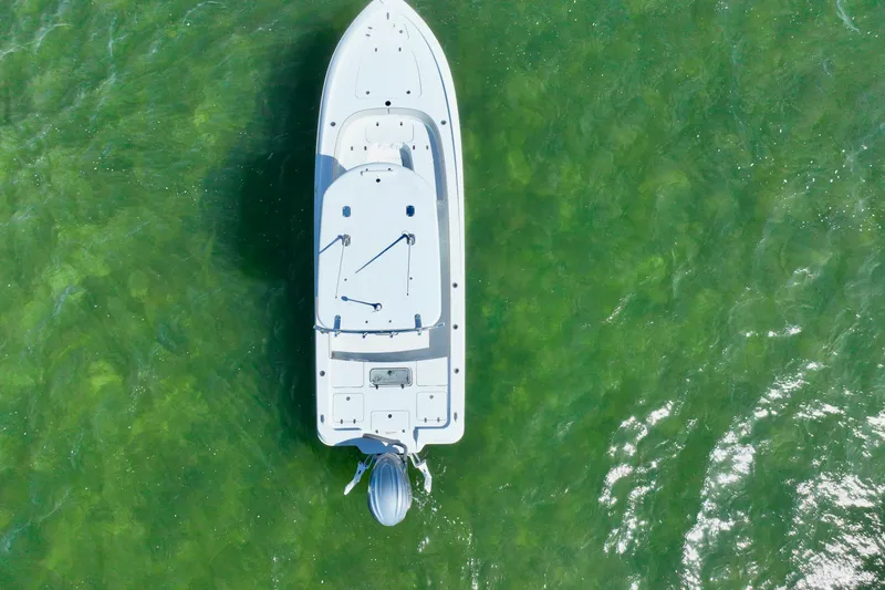 Slide: The Image of Aerial view of 2025 Contender 26 Bay boat on clear green water. - 34