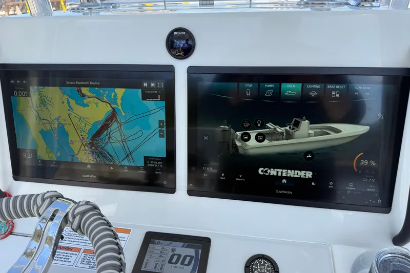 Slide: The Image of 2025 Contender 26 Bay boat dashboard with Garmin navigation and control screens. - 36