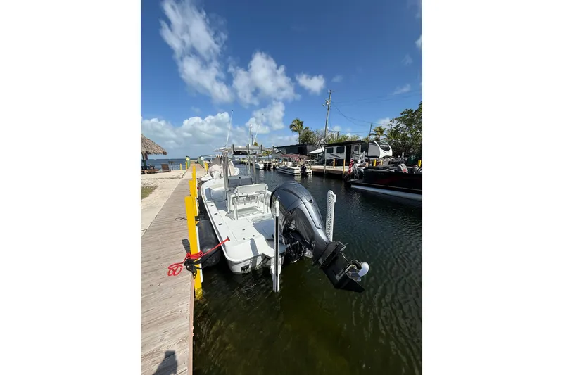 Slide: The Image of 2025 Contender 26 Bay boat docked at a sunny marina. - 37
