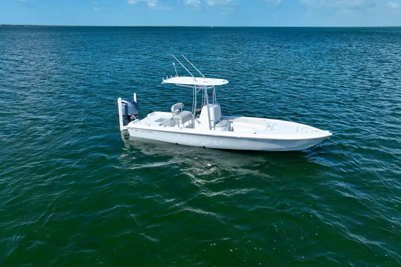 Slide: The Image of 2025 Contender 26 Bay boat on open water under clear sky. - 4