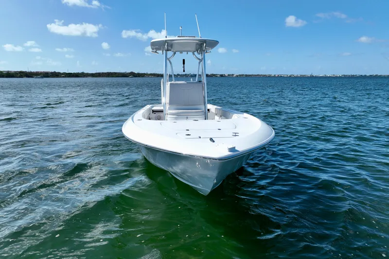 Slide: The Image of 2025 Contender 26 Bay boat on calm blue water under clear sky. - 5