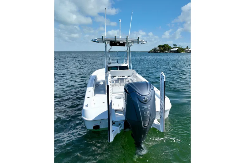 Slide: The Image of 2025 Contender 26 Bay boat with powerful outboard motor on open water. - 7