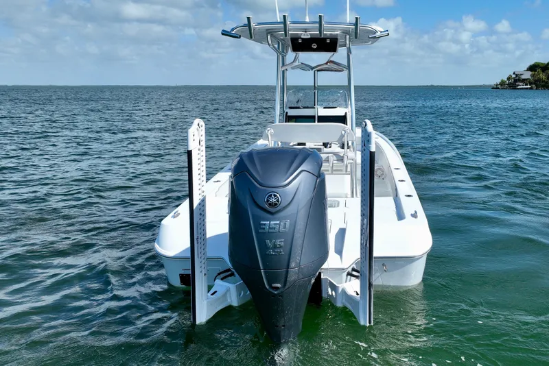Slide: The Image of 2025 Contender 26 Bay boat with powerful 350 V8 engine on open water. - 8
