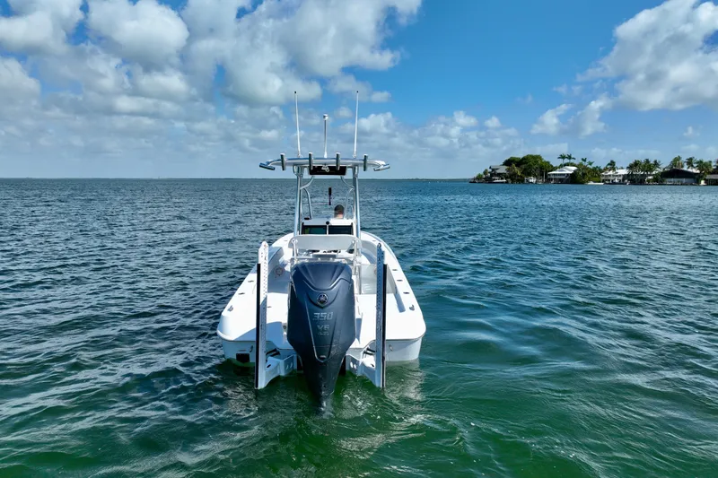Slide: The Image of 2025 Contender 26 Bay boat on open water under a blue sky. - 9